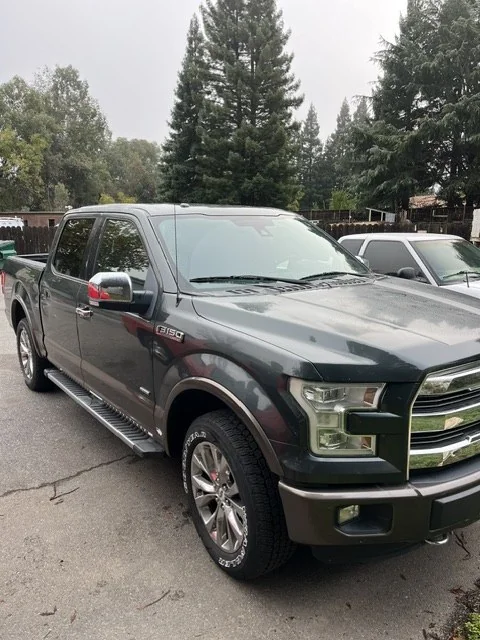 Green two-tone aluminum-bodied Ford F-150 after completed repair, front three-quarter view