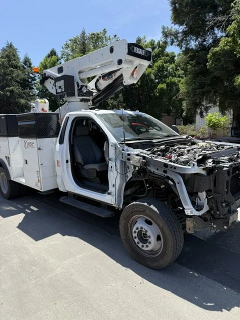 The boom truck cab stripped to structure during repair