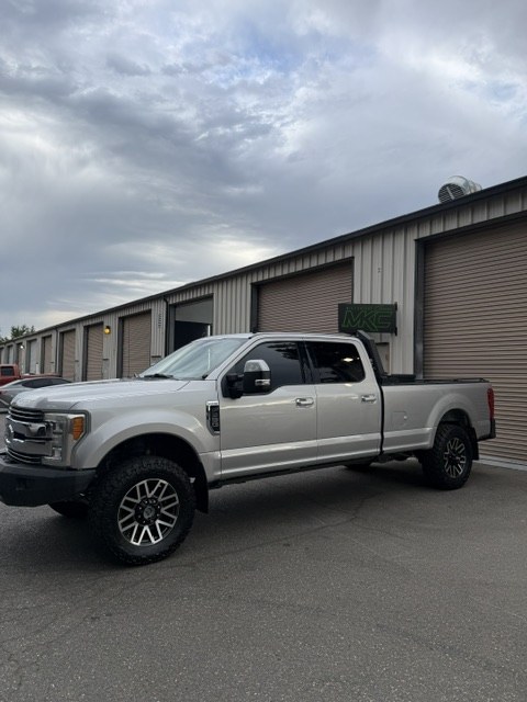 Side profile of the repaired F350 outside the shop