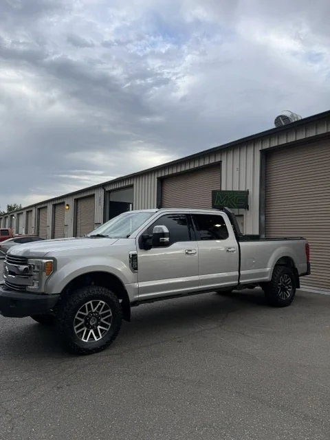 Side profile of the repaired F350 outside the shop