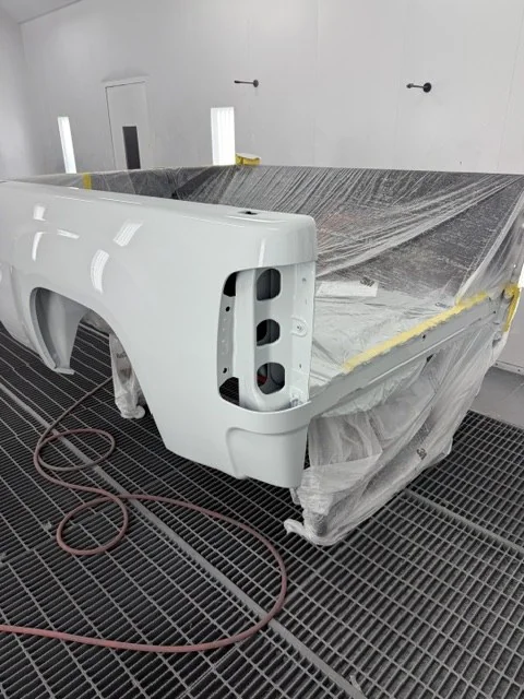 The Sierra's bed masked and refinished in the spray booth