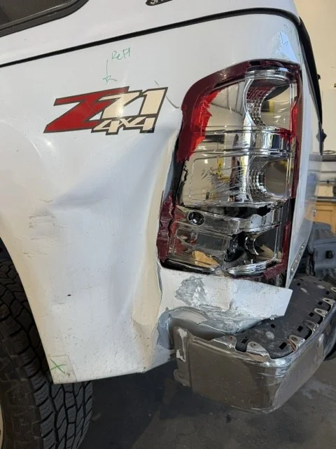 2011 GMC Sierra with rear quarter and bumper collision damage, before repair