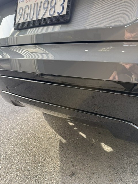 Close view of the repaired rear bumper panel gaps on the 2024 Range Rover