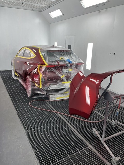 Body panels and the Venza under booth lighting during the candy red paint process