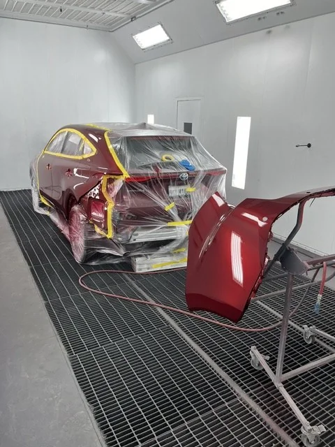 Body panels and the Venza under booth lighting during the candy red paint process